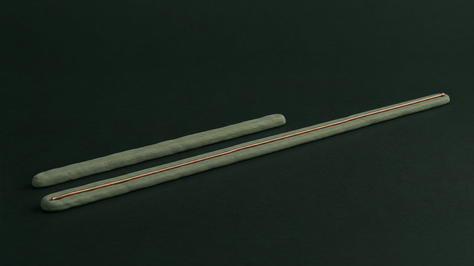 Two sage clay lanes on a dark green surface, the longer one carrying a copper thread